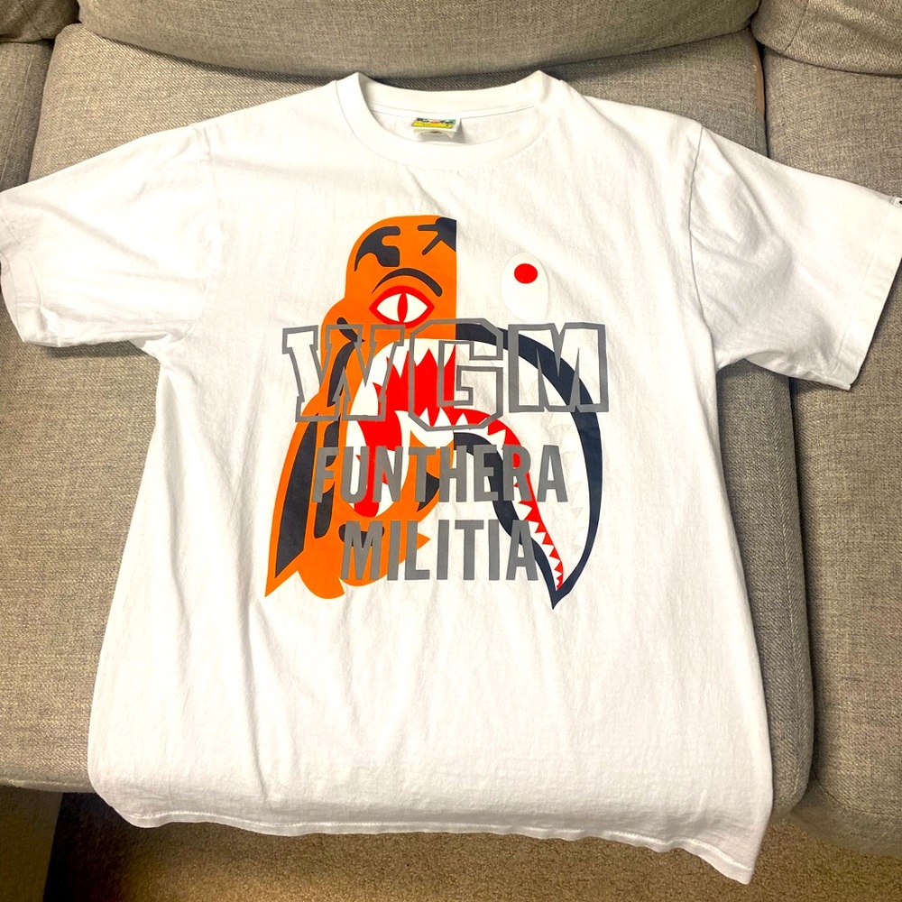 This is a Small mens Bape t-shirt that is primarily white, orange, and gray.